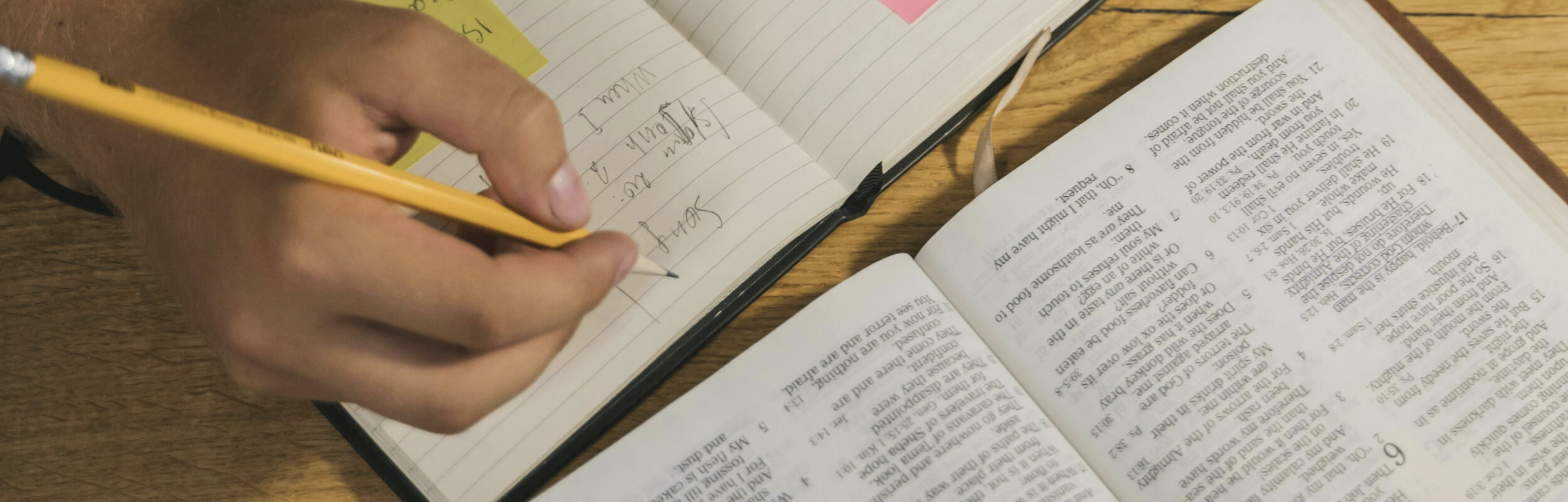 A person taking notes at a table